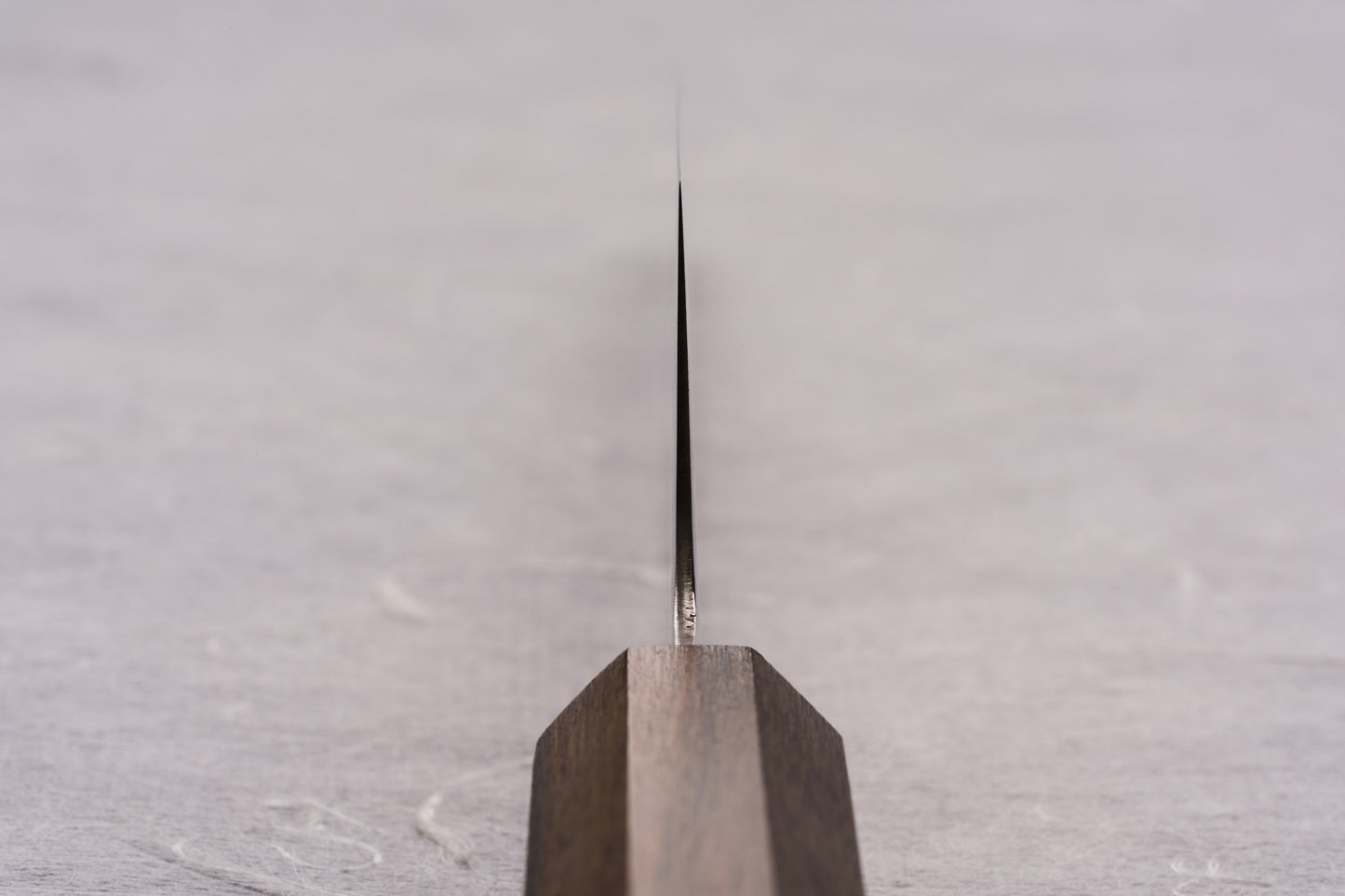 ICHIGO SLD Migaki Gyuto 150mm knife, featuring a polished, thin blade and simple wooden handle, designed for precision cutting of small ingredients. Perfectly crafted for Japanese knife enthusiasts at Knifewear.