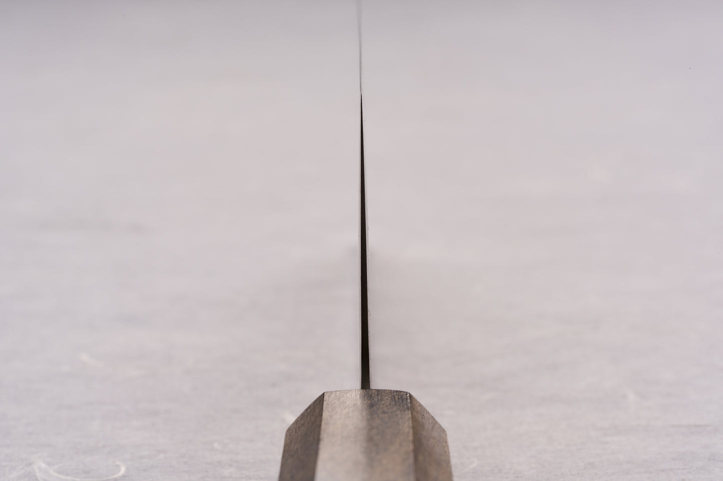 Edge-on view of the ICHIGO SLD Migaki Nakiri 160mm, showcasing its ultra-thin blade and dark wooden handle, ideal for effortless vegetable chopping with Japanese precision and craftsmanship.