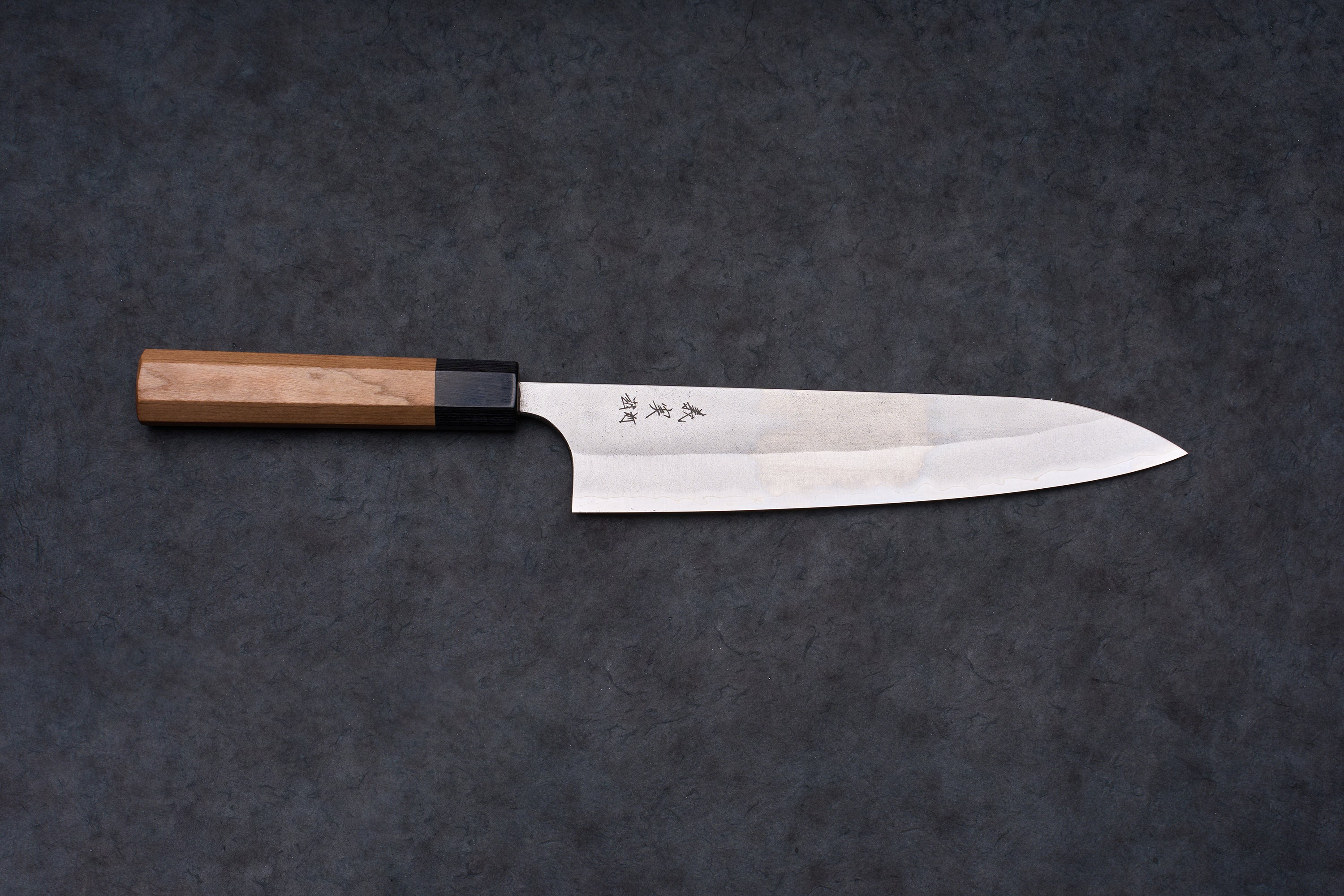 Yoshimi Kato AS/S Nashiji Gyuto 210mm features a stainless-steel blade with kanji etching and octagonal wooden handle, ideal for versatile culinary tasks.