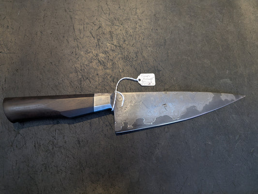 Black Cat Metal Wrought Iron Go Mai Chef knife with a Damascus-like blade finish and African blackwood handle, crafted by blacksmith Chris Green.