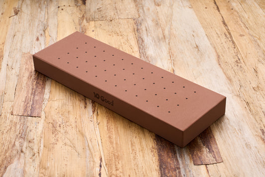 10 Good Medium 1000 Grit Stone in a perforated box, ideal for beginners in knife sharpening, offering tactile guidance for ergonomic grip.