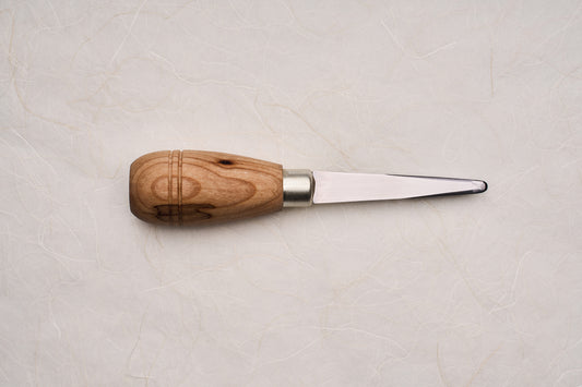 Banjo Islander Pro Oyster Knife with a polished wooden handle and flat steel blade, designed for competitive oyster shucking. Ideal for precision tasks, crafted with PEI Red Cedar, showcasing expert craftsmanship.