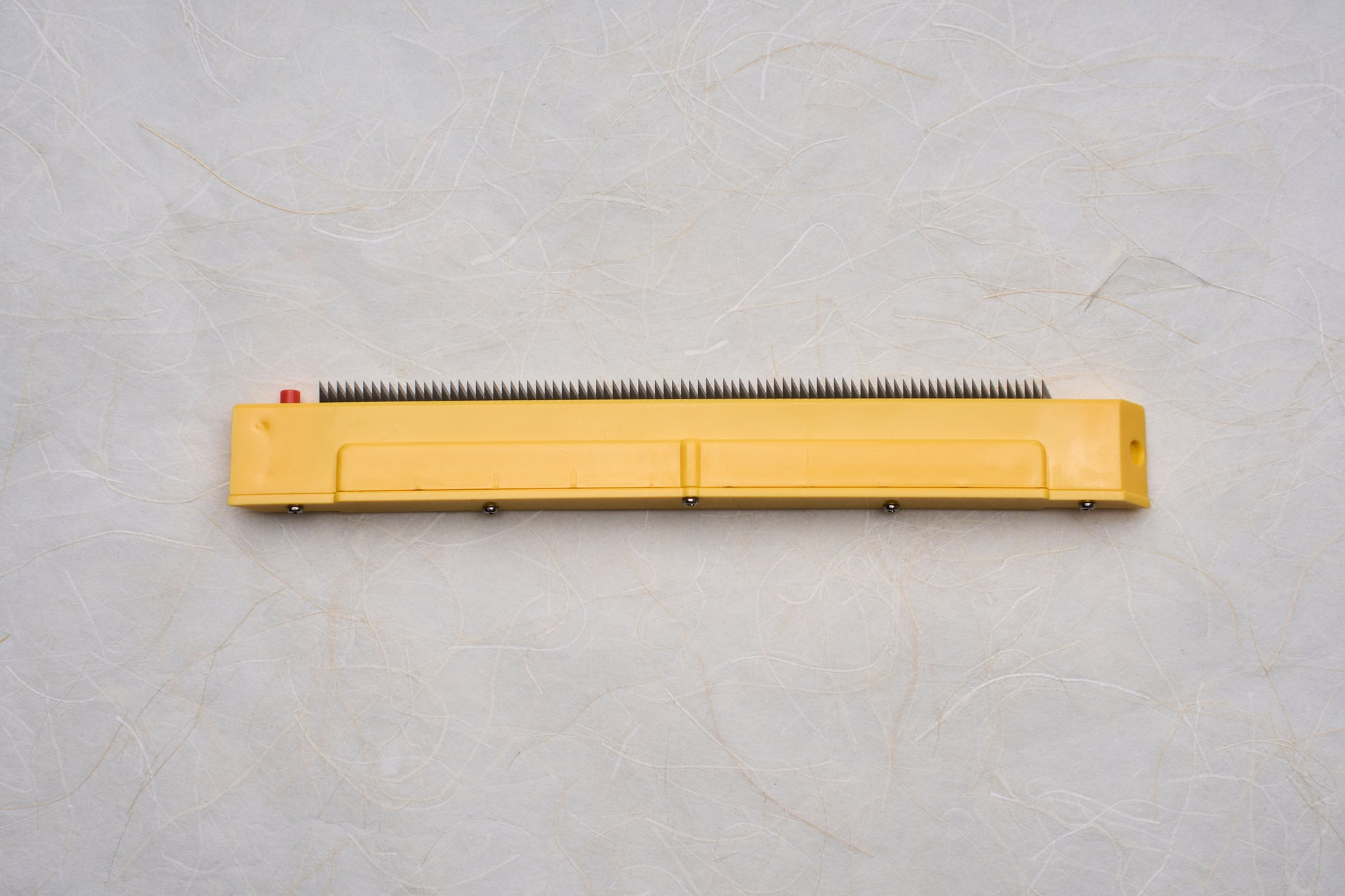 Replacement Blades for Chiba Mandoline Slicers, featuring a yellow plastic housing and metal teeth, suitable for precise slicing tasks in culinary applications.