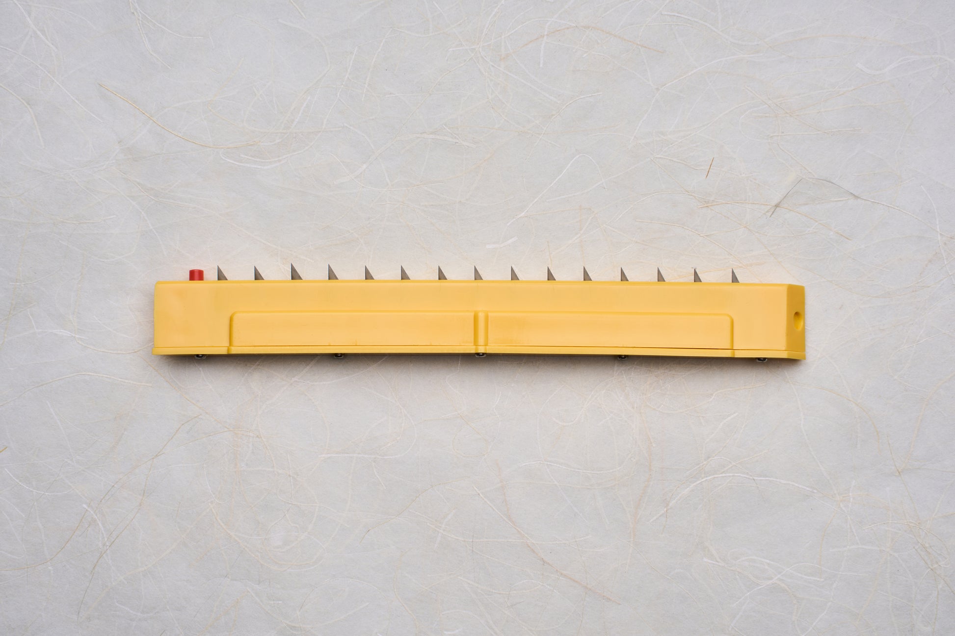 Replacement Blades for Chiba Mandoline Slicers featuring a yellow applicator with triangular metal teeth and a red button, ideal for precise slicing in culinary applications.