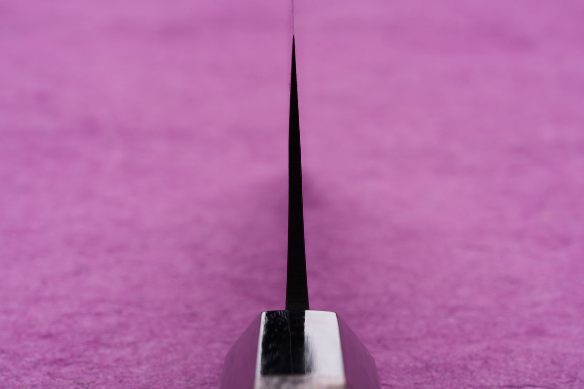 Fujimoto AS Sazanami Nakiri 165mm knife edge-on view, showcasing its razor-thin blade and shiny steel bolster, designed for precise vegetable chopping.