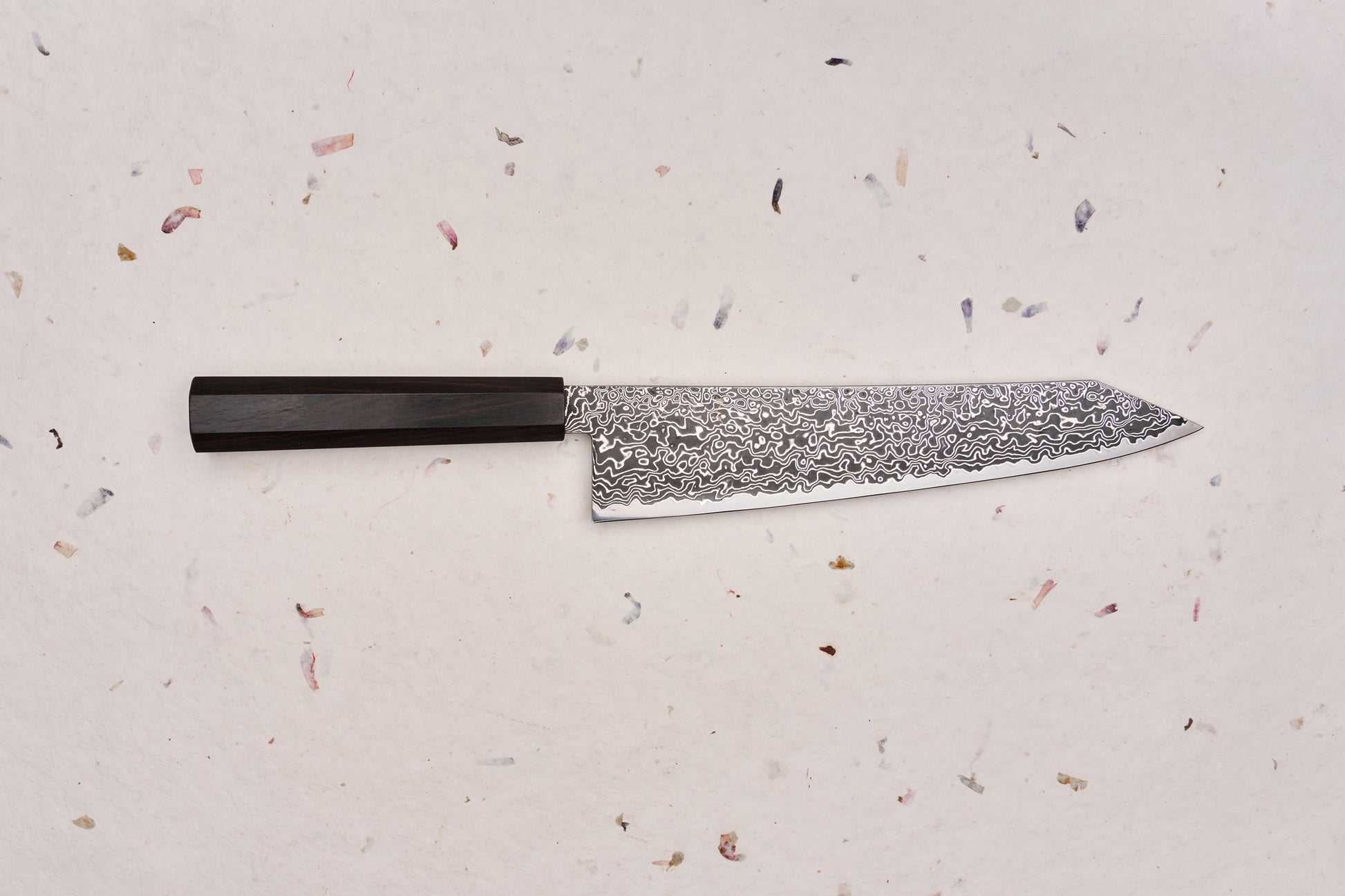 Hatsukokoro Ryuhyo SG2 Kurozome Damascus Kiritsuke Gyuto 240mm, featuring a Damascus-patterned blade and dark octagonal handle, embodying Japanese craftsmanship with a sleek, multi-purpose design.