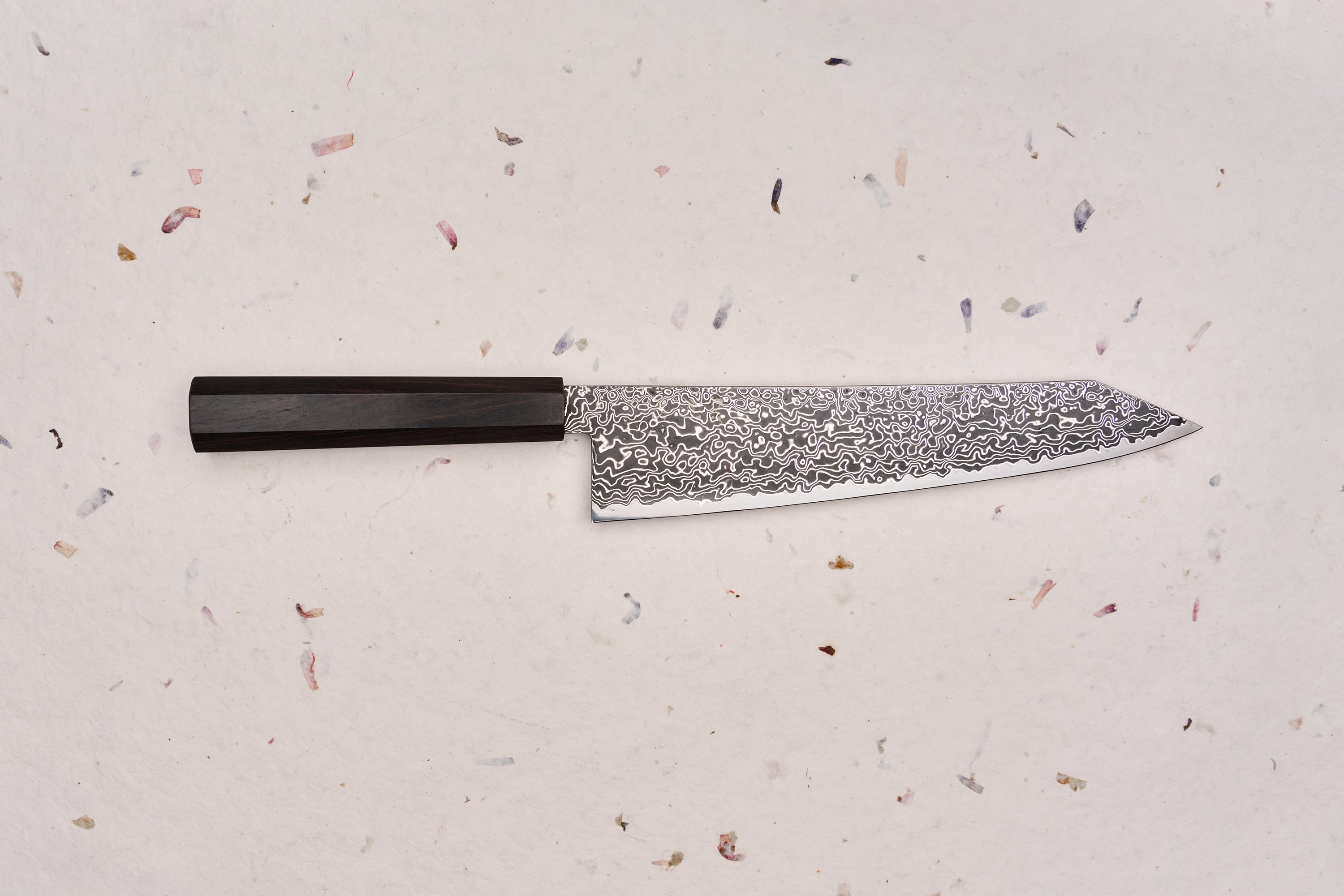 Hatsukokoro Ryuhyo SG2 Kurozome Damascus Kiritsuke Gyuto 240mm, featuring a Damascus-patterned blade and dark octagonal handle, embodying Japanese craftsmanship with a sleek, multi-purpose design.