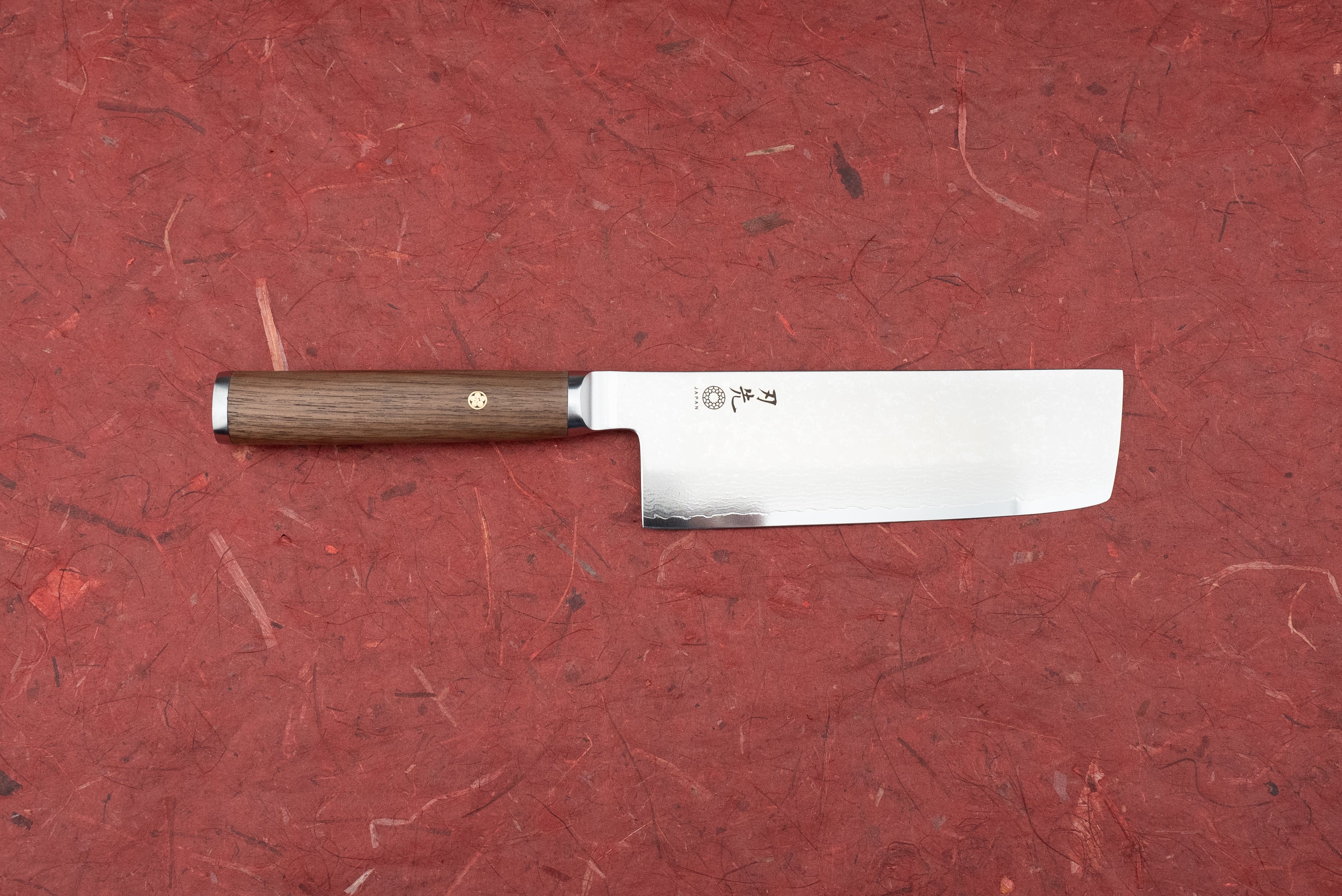 Hazaki Pro Series Nakiri 165mm features a straight, rectangular blade with Japanese engravings and a hammered pattern, paired with a dark wood handle and decorative brass mosaic pin.