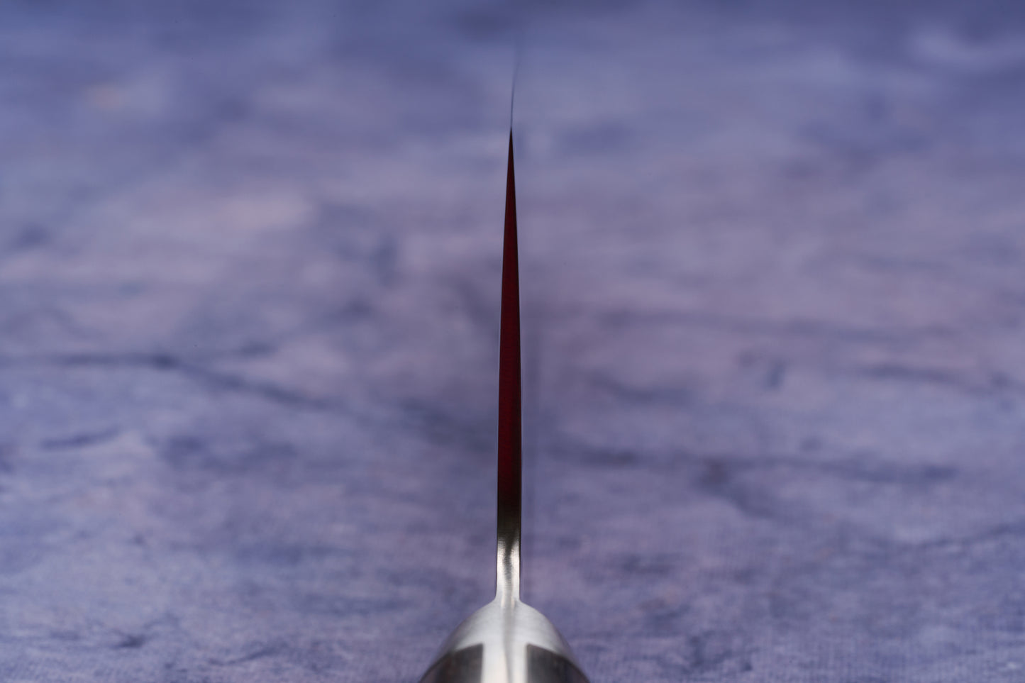 Hazaki Classic Black Gyuto 210mm knife edge-on view, showcasing its thin, sharp blade crafted from AUS10 steel, embodying the fusion of Japanese forging and Canadian craftsmanship.