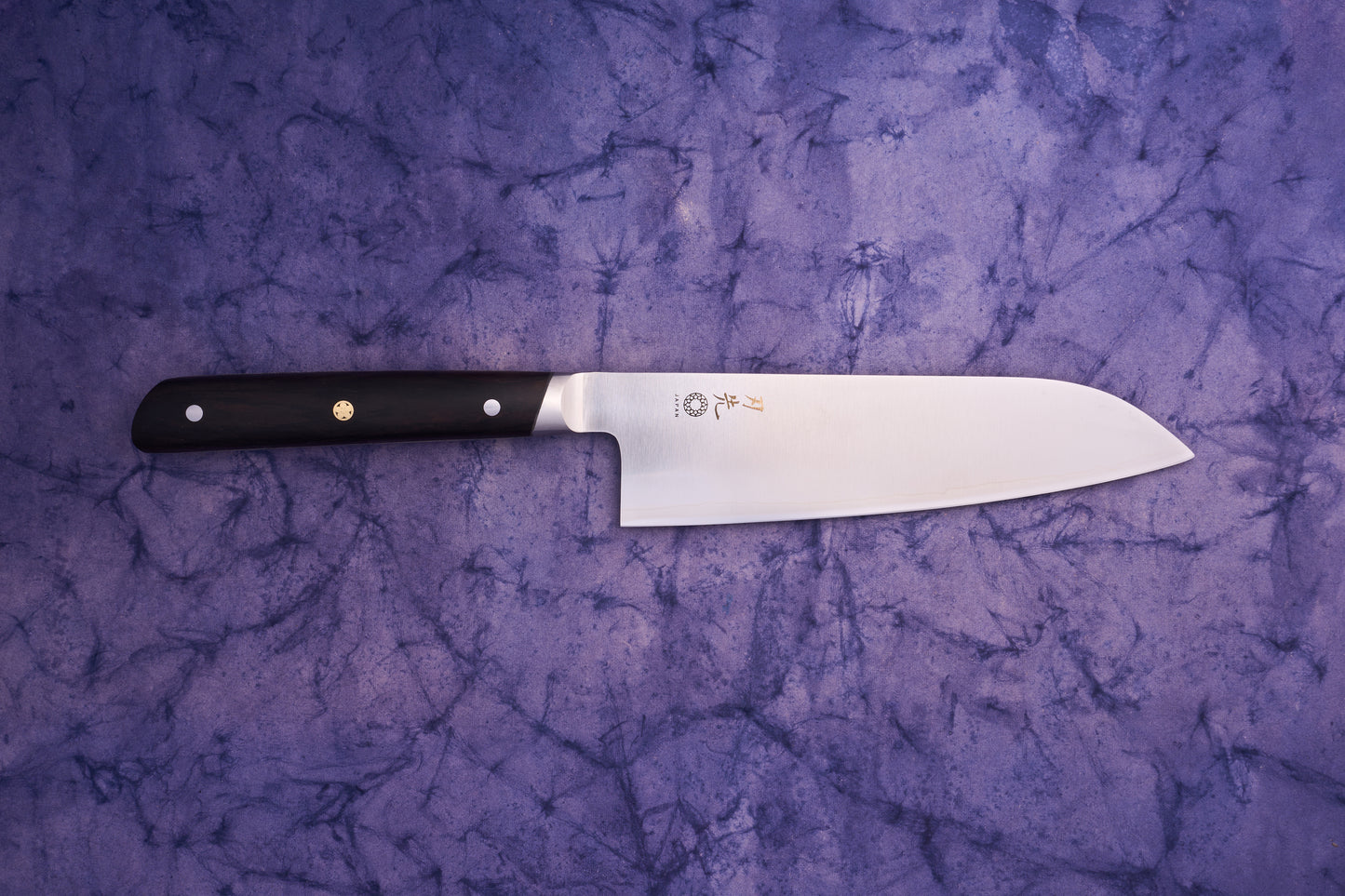 Hazaki Classic Black Santoku 180mm features a straight-edged stainless steel blade with Japanese characters, paired with a dark wood handle. Perfectly balances Japanese craftsmanship and Canadian artistry.