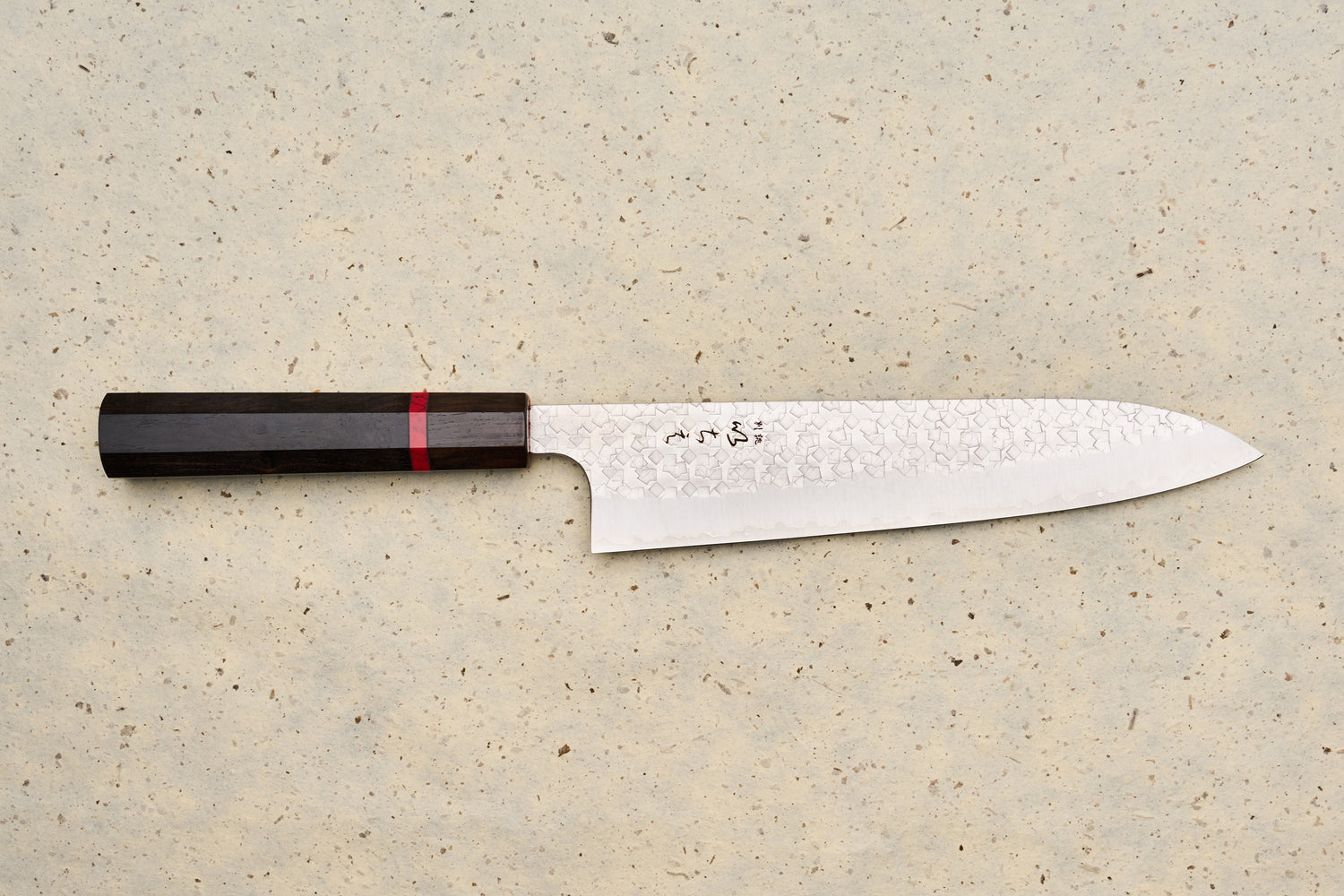 ICHIE x Shibata Knives SG2 Tsuchime Gyuto 210mm features a hammered blade, octagonal dark wood handle, and stamped Japanese characters, ideal for versatile culinary use.