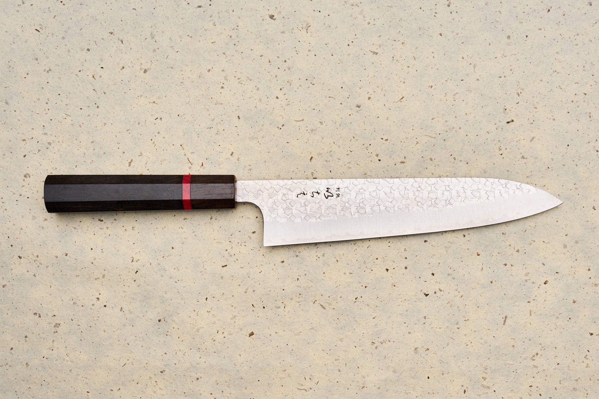 ICHIE x Shibata Knives SG2 Tsuchime Gyuto 210mm features a hammered blade, octagonal dark wood handle, and stamped Japanese characters, ideal for versatile culinary use.