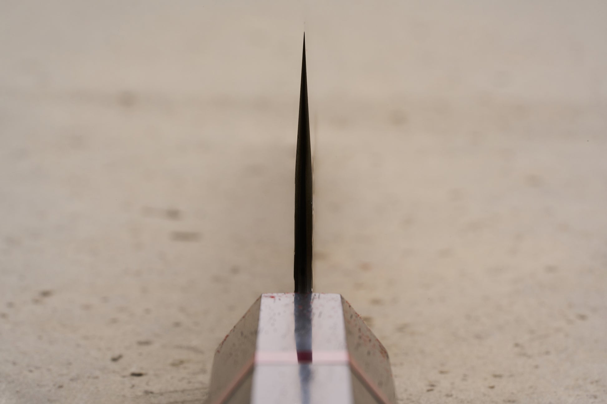 ICHIE x Shibata Knives SG2 Tsuchime Gyuto 210mm knife's sleek design is reminiscent of a surfboard fin, highlighting its precise craftsmanship and unique form, embodying the store's dedication to exceptional Japanese steel.