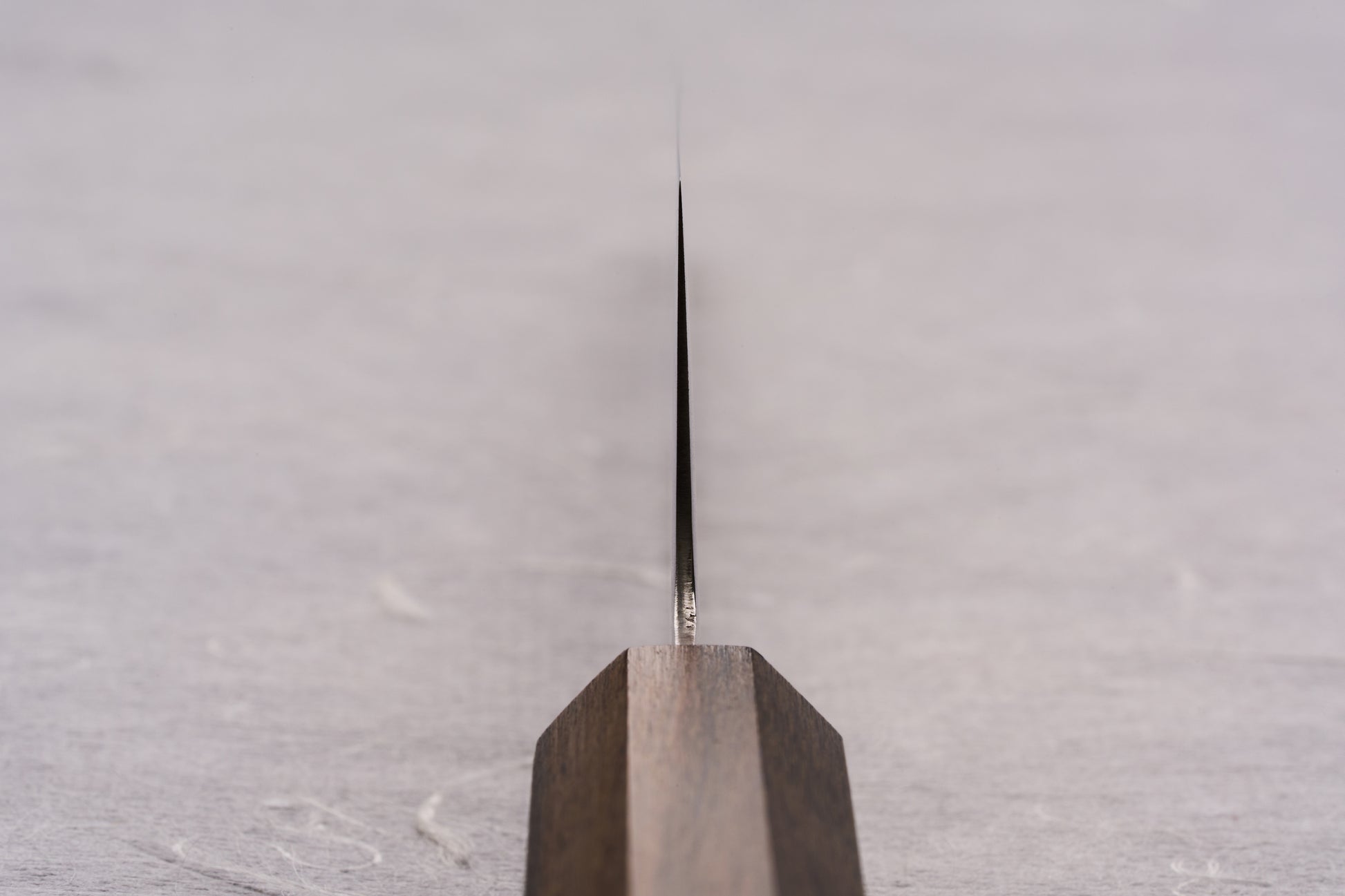 ICHIGO SLD Migaki Gyuto 150mm knife, featuring a polished, thin blade and simple wooden handle, designed for precision cutting of small ingredients. Perfectly crafted for Japanese knife enthusiasts at Knifewear.