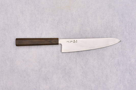 ICHIGO SLD Migaki Gyuto 195mm displayed flat, features a polished steel blade with engraved Japanese characters near the heel and an octagonal wooden handle, embodying Japanese craftsmanship.