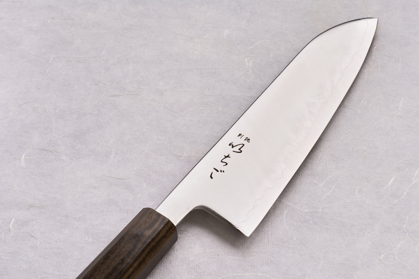 ICHIGO SLD Migaki Santoku 170mm knife with a polished stainless steel blade featuring a hamon and kanji, and an octagonal dark wood handle, embodying Japanese craftsmanship and sharpness ideal for versatile kitchen tasks.
