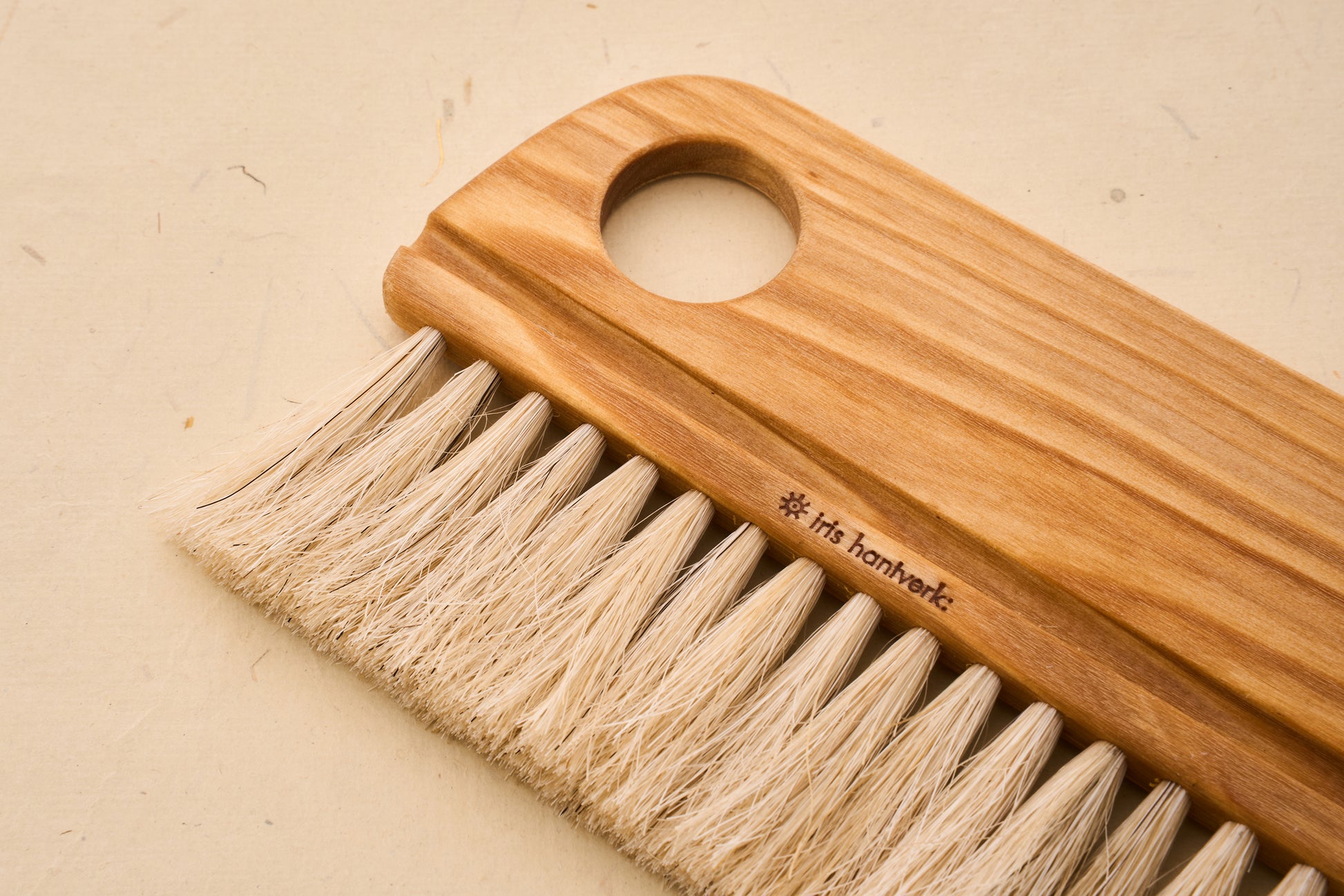 Close-up of the Iris Hantverk Baker's Brush with a smooth beechwood handle and horsehair bristles, ideal for flour spreading and surface cleaning.