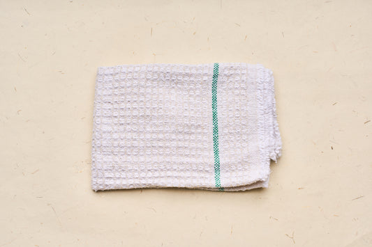 Iris Hantverk Cleaning Cloth, featuring a waffle-weave texture and green stripe, made from 100% recycled cotton, ideal for kitchen or cleaning tasks.