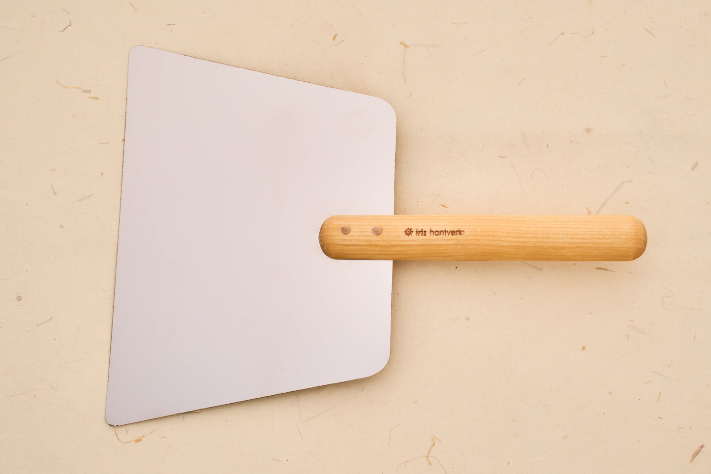 Iris Hantverk Dough Scraper with Handle, featuring a flat metal blade and turned-wood grip, ideal for dough management and griddle use.
