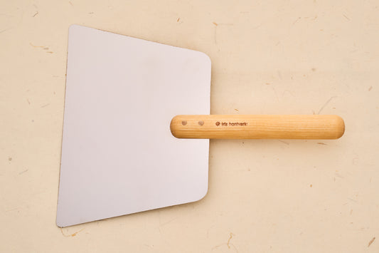 Iris Hantverk Dough Scraper with Handle, featuring a flat metal blade and turned-wood grip, ideal for dough management and griddle use.