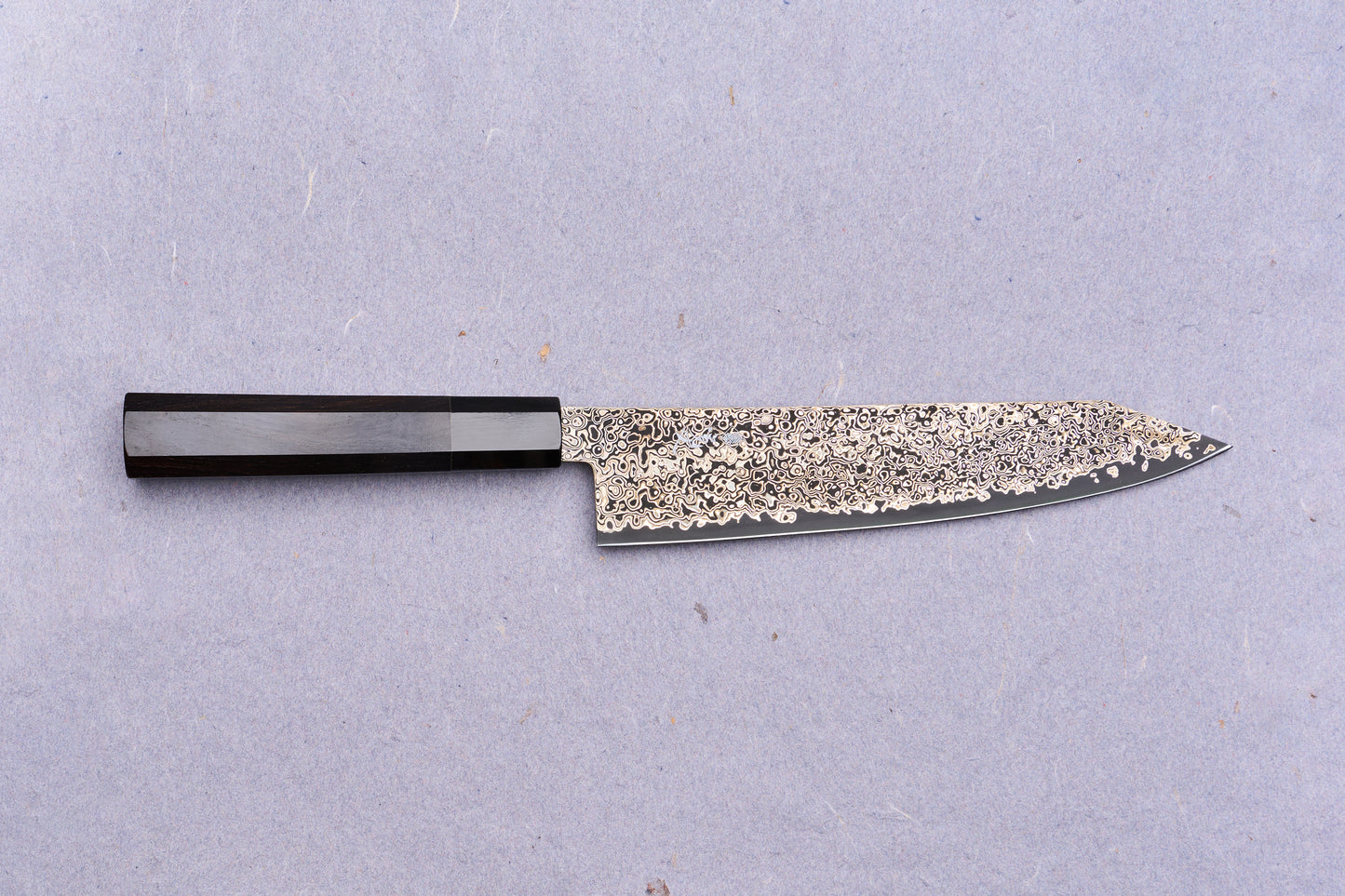Kanjo SG2 Nickel Damascus Kiritsuke Gyuto 210mm: A Japanese chef's knife featuring a patterned Damascus blade and dark octagonal wooden handle, ideal for versatile kitchen tasks.