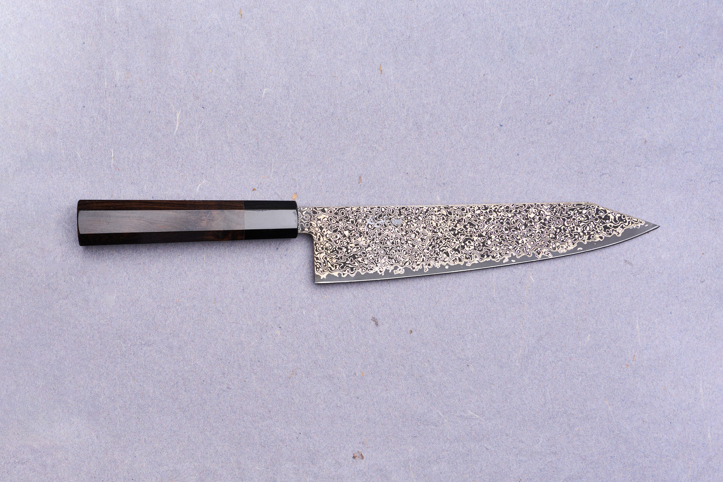 Kanjo SG2 Nickel Damascus Kiritsuke Gyuto 240mm with a dark wooden octagonal handle and intricate Damascus-steel blade, ideal for versatile culinary use.
