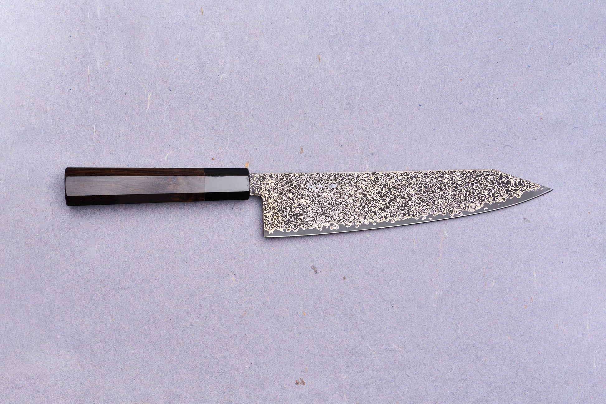 Kanjo SG2 Nickel Damascus Kiritsuke Gyuto 240mm with a dark wooden octagonal handle and intricate Damascus-steel blade, ideal for versatile culinary use.