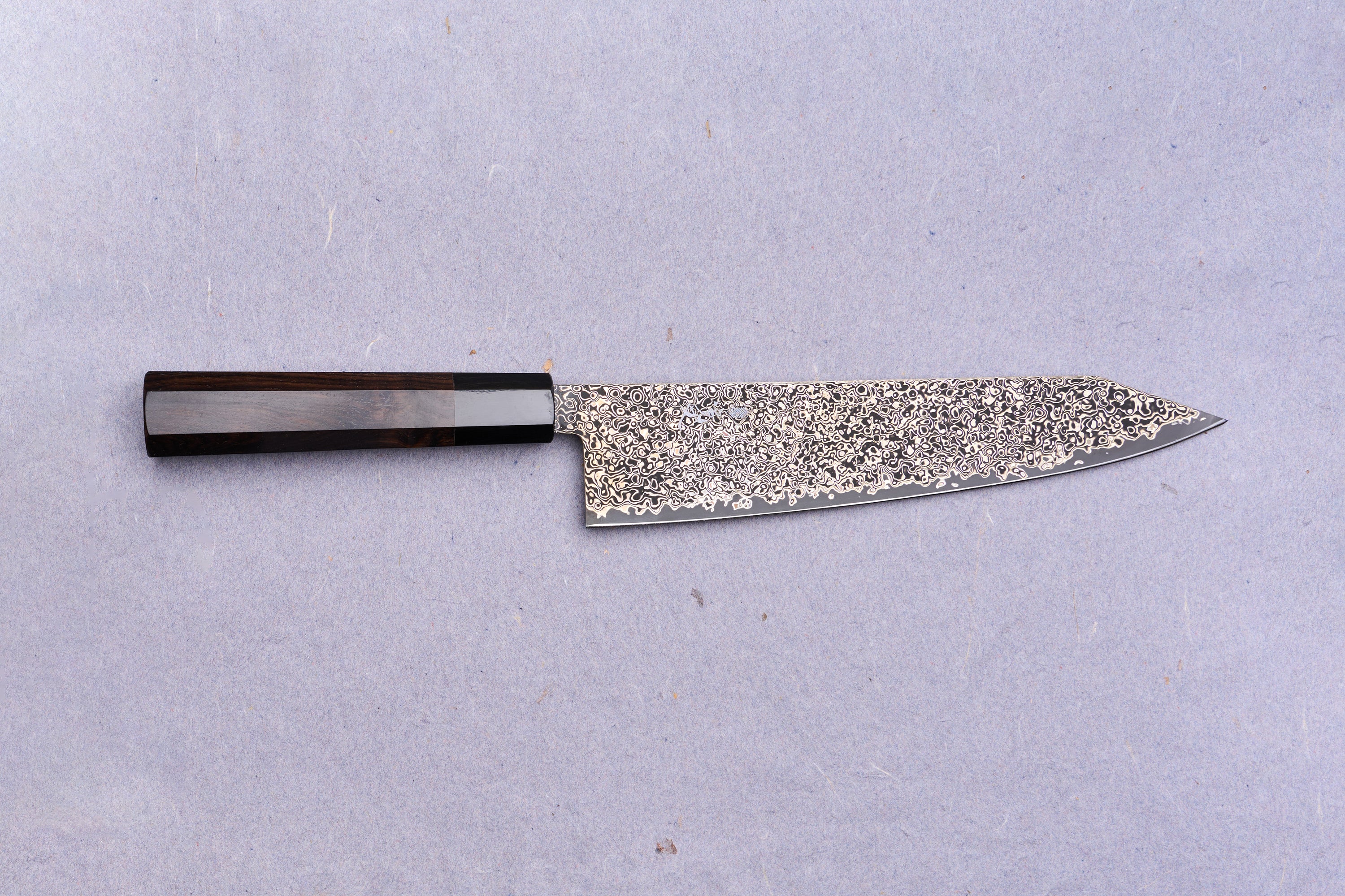 Kanjo SG2 Nickel Damascus Kiritsuke Gyuto 240mm with a dark wooden octagonal handle and intricate Damascus-steel blade, ideal for versatile culinary use.