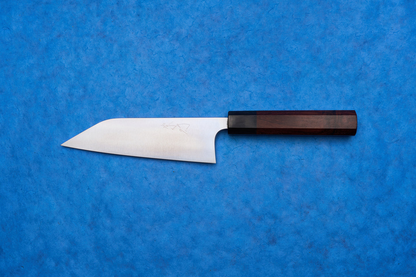 Shibata Koutetsu Chromax Migaki Santoku 165mm knife with a stainless-steel blade and octagonal wooden handle, ideal for slicing, dicing, and mincing, captures Japanese craftsmanship for versatile kitchen use.
