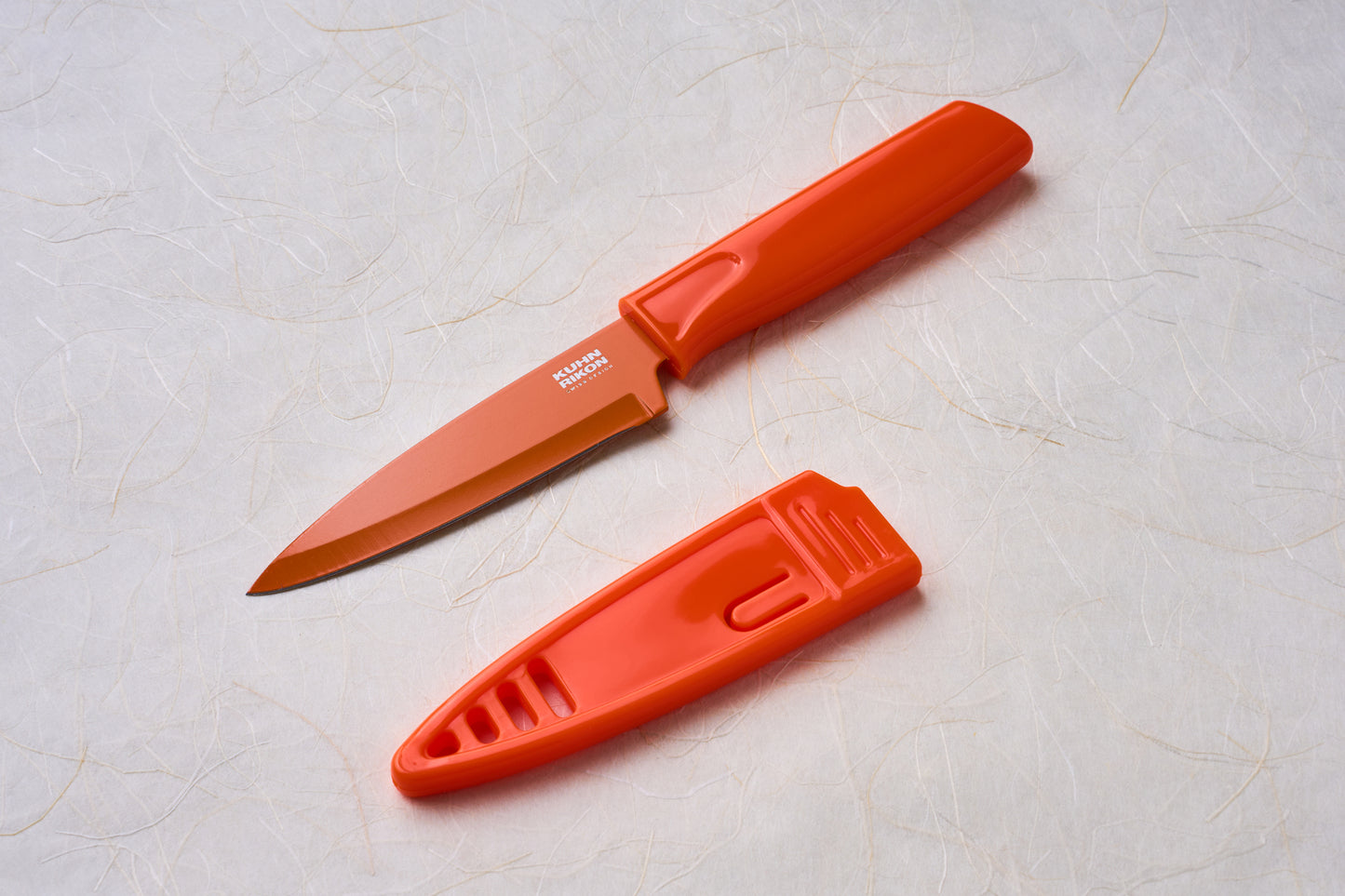Kuhn Paring Knives with red handle and sheath, featuring durable VG10 stainless steel blade, ideal for versatile kitchen tasks and safe storage.