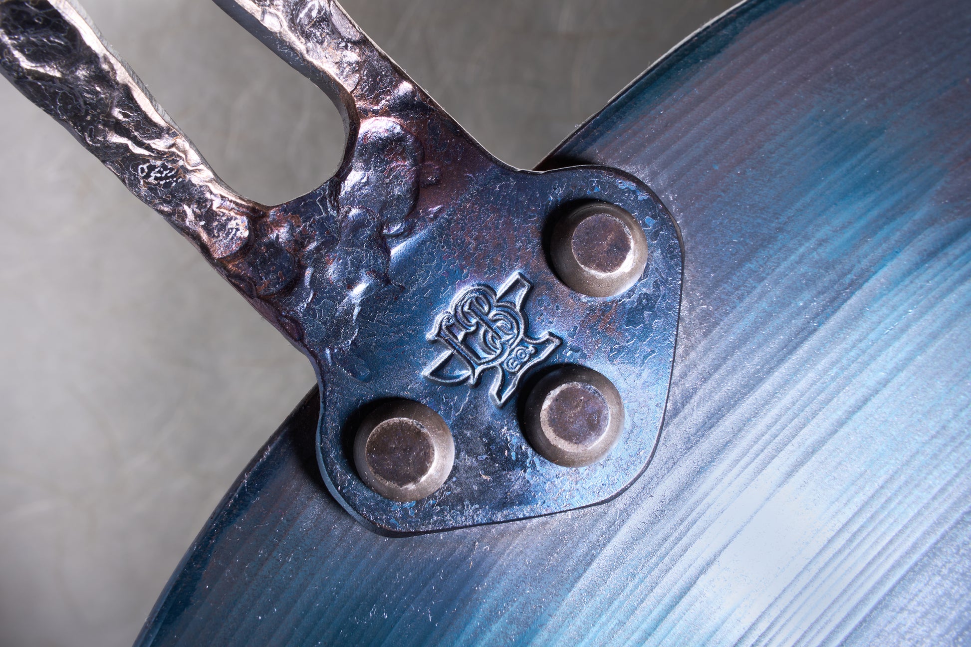 Leechtown Blacksmith Co. Mokwok Carbon Steel Pan Small, showcasing a riveted handle with a stamped logo on hand-forged steel, ideal for diverse cooking surfaces.