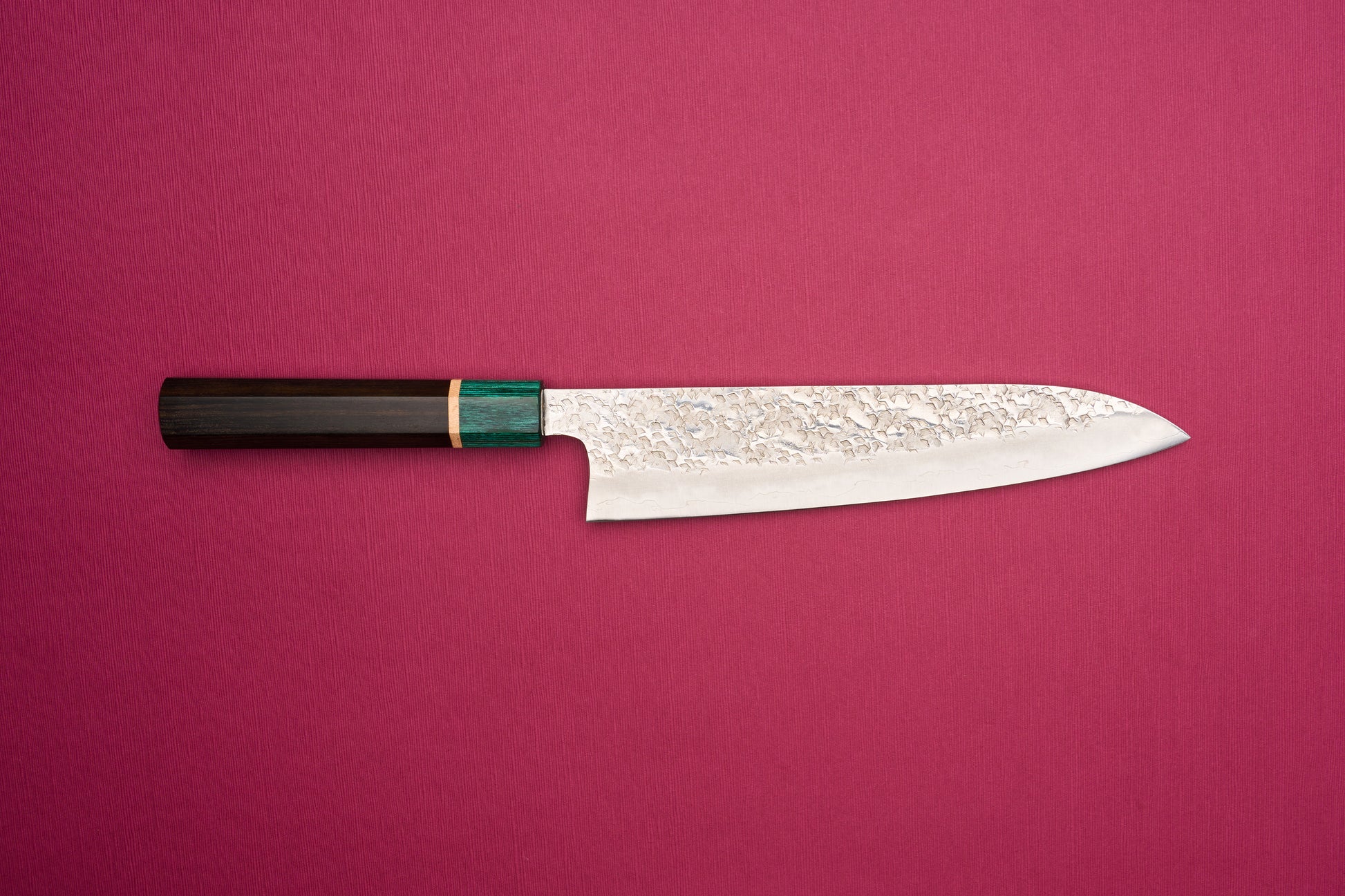 Makoto Kurosaki SPG STRIX Samidorizuki Gyuto 210mm features a hammered blade and octagonal wooden handle, embodying Japanese craftsmanship. Ideal for versatile kitchen use, inspired by European chef knife design.