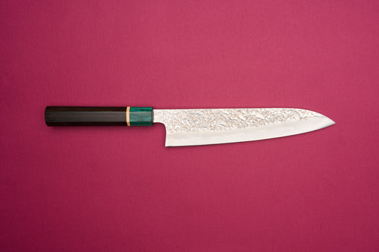 Makoto Kurosaki SPG STRIX Samidorizuki Gyuto 210mm features a hammered blade and octagonal wooden handle, embodying Japanese craftsmanship. Ideal for versatile kitchen use, inspired by European chef knife design.