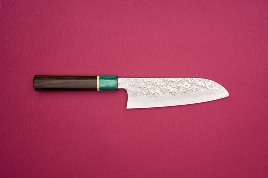 Makoto Kurosaki SPG STRIX Samidorizuki Santoku 165mm knife with a hammered blade and octagonal dark wood handle, featuring a greenish bolster, ideal for slicing, dicing, and mincing vegetables.