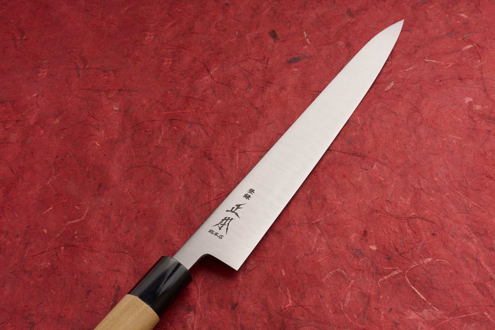 Masamoto KS Hongasumi Sujihiki 270mm, a precision Japanese slicing knife, features a polished steel blade with kanji near the bolster and an octagonal wooden handle, perfect for effortless, clean cuts.