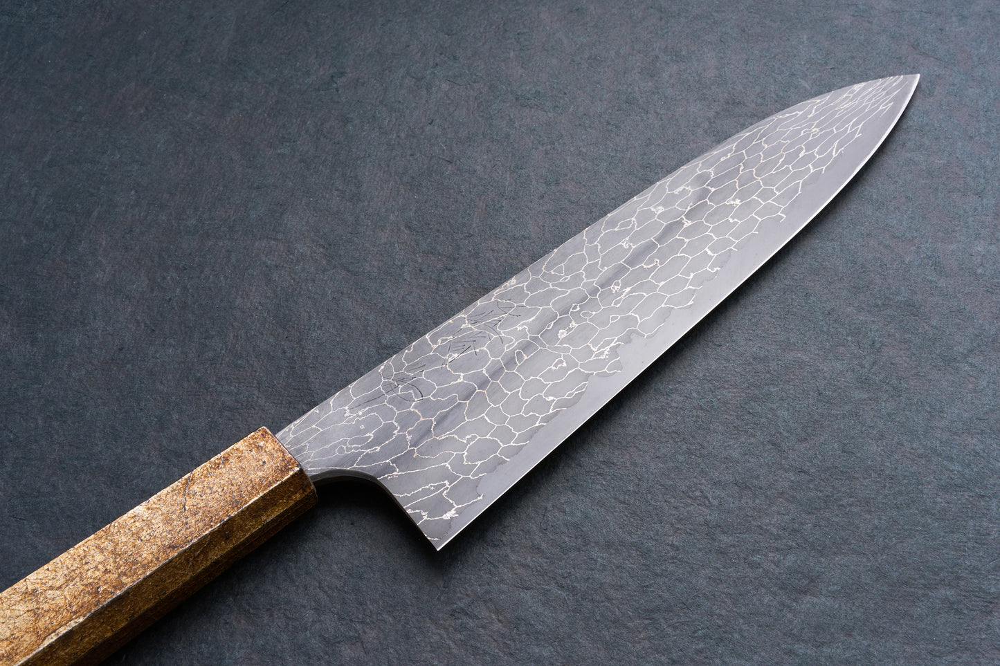 Mazaki Aoichi Beads Black Damascus Gyuto 240mm, featuring a hammered blade texture and octagonal wooden handle, embodies precision craftsmanship for versatile kitchen use.
