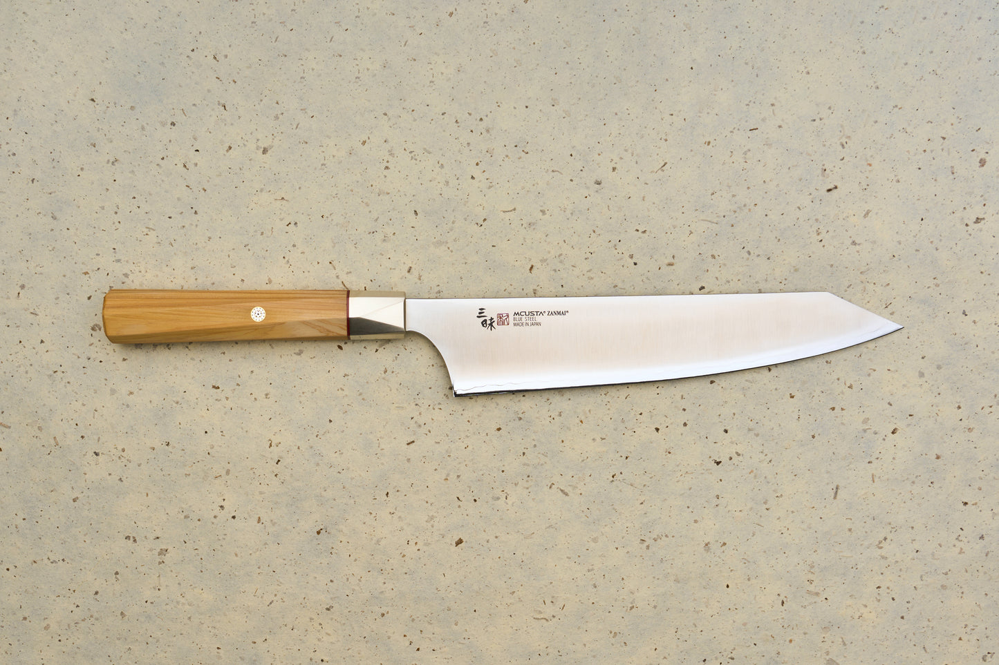 Mcusta Zanmai Beyond Kiritsuke Gyuto 210mm features a polished blue-steel blade with Japanese inscriptions and a Hinoki wood handle, showcasing craftsmanship ideal for those passionate about precision Japanese kitchen tools.