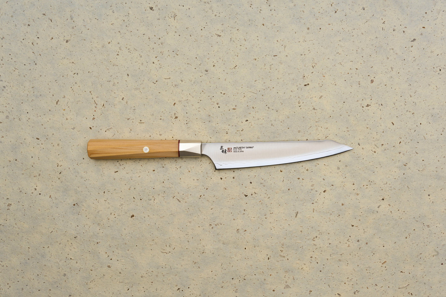 Mcusta Zanmai Beyond Kiritsuke Petty 150mm knife with a sleek, single-bevel stainless-steel blade etched with Japanese characters and an octagonal wooden handle, ideal for precision slicing and sashimi preparation.