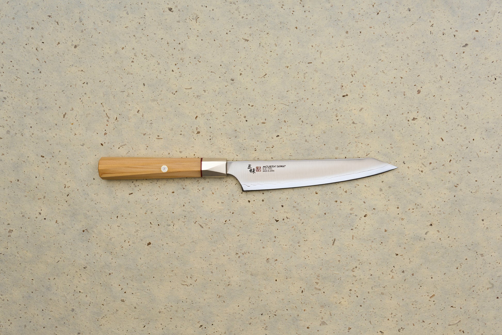 Mcusta Zanmai Beyond Kiritsuke Petty 150mm knife with a sleek, single-bevel stainless-steel blade etched with Japanese characters and an octagonal wooden handle, ideal for precision slicing and sashimi preparation.