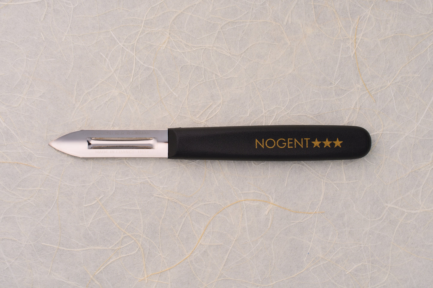 Nogent Double Edge Peeler with stainless-steel blade and black handle, ideal for thin, dual-directional peeling, embodying quality craftsmanship synonymous with renowned cutlery maker Nogent.