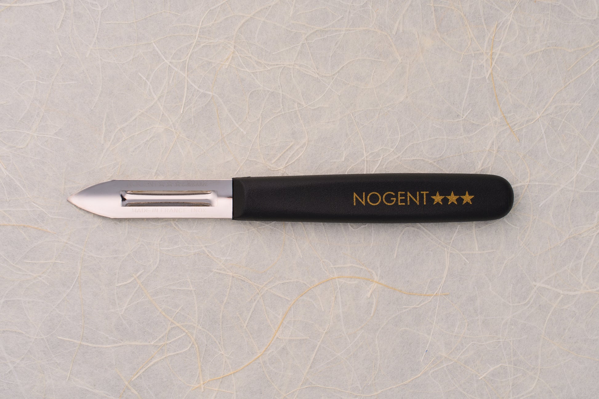 Nogent Double Edge Peeler with stainless-steel blade and black handle, ideal for thin, dual-directional peeling, embodying quality craftsmanship synonymous with renowned cutlery maker Nogent.