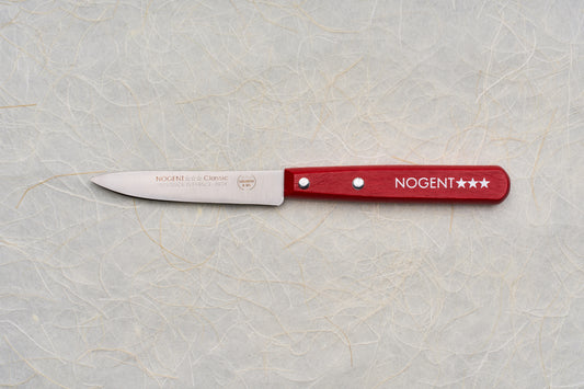 Nogent Paring Knife with a stainless-steel blade and red wooden handle, showcasing French craftsmanship and quality, displayed on a light paper background.
