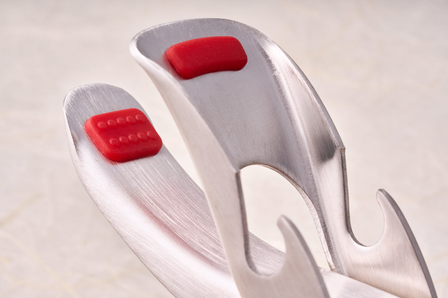 Shimoyama Stainless Steel Bowl Clip: Three stainless-steel serving tools with red silicone grips, including a solid, slotted, and pasta spoon, arranged in a fan.