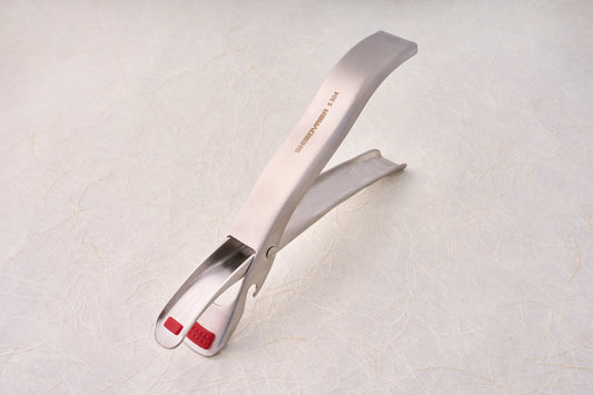 Shimoyama Stainless Steel Bowl Clip with red silicone grip pads, ideal for serving or grilling, reflecting Knifewear's dedication to quality chef tools.