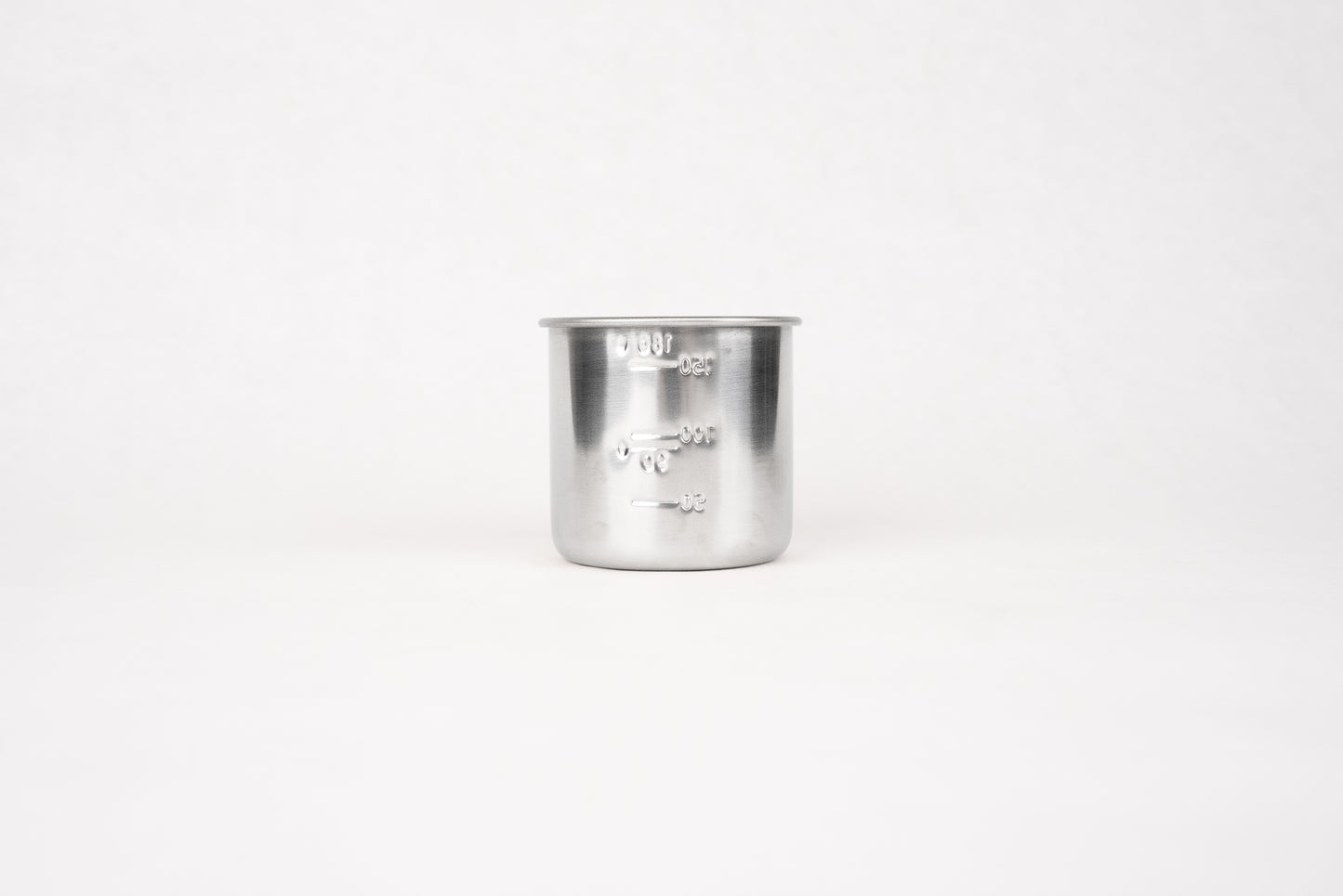Stainless Steel Measuring Cup for Rice 180ml, featuring embossed volume markings, ideal for precise rice measurement. This traditional Japanese kitchen tool complements Knifewear's curated selection of handcrafted chef essentials.
