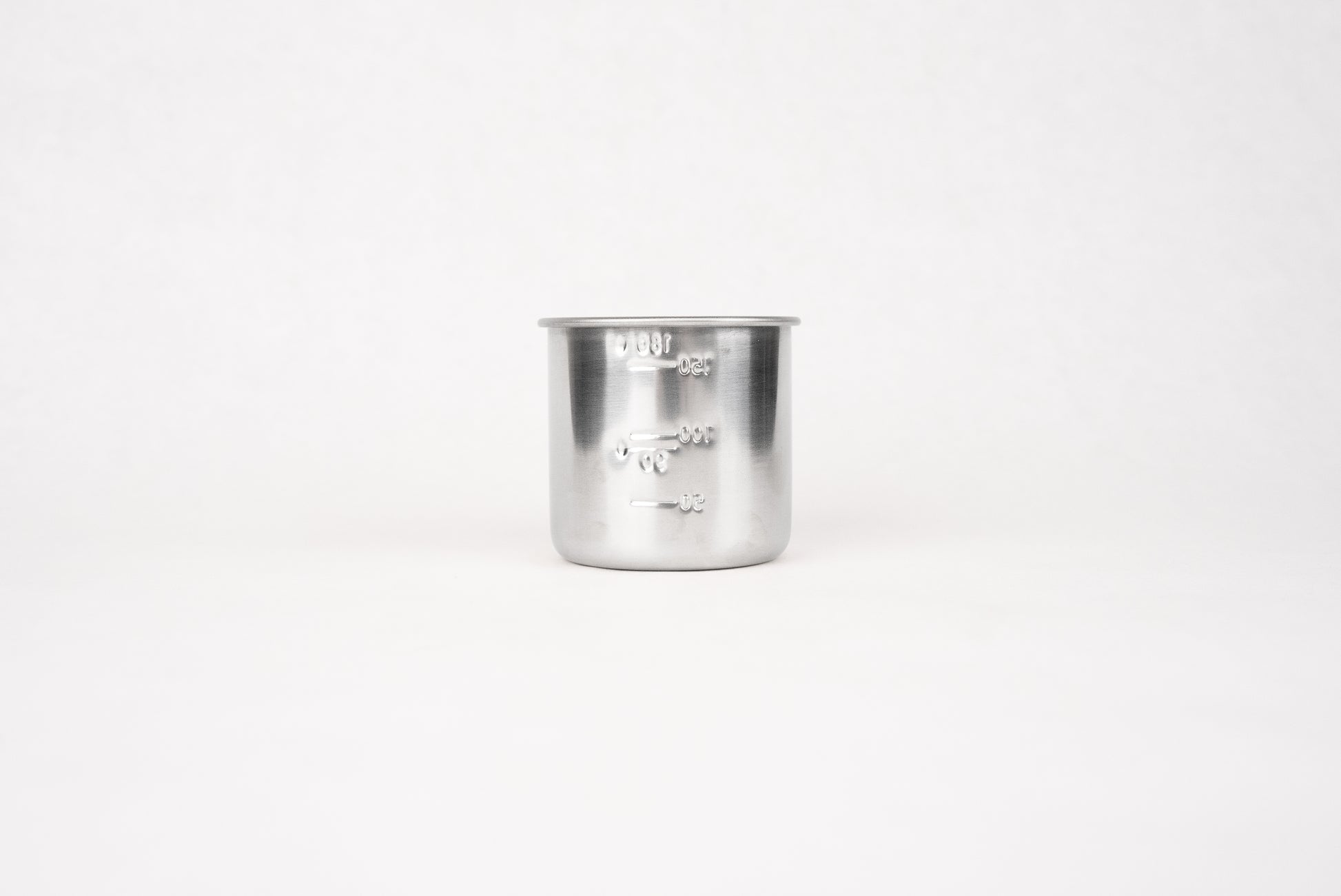 Stainless Steel Measuring Cup for Rice 180ml, featuring embossed volume markings, ideal for precise rice measurement. This traditional Japanese kitchen tool complements Knifewear's curated selection of handcrafted chef essentials.