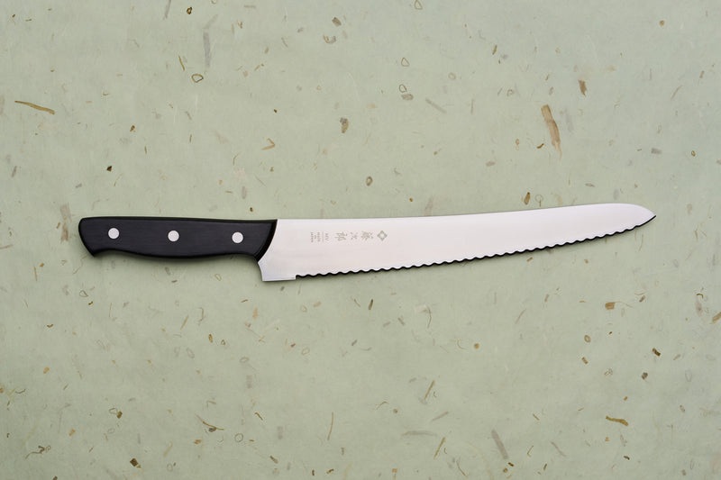 TOJIRO Bread knife 270mm F-687 with scalloped serrations and a black riveted handle, designed for effortlessly slicing bread while minimizing crumbs.