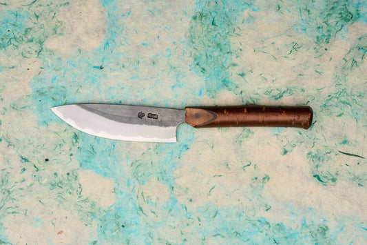 Tottori Otsuka Hamono Aoichi Yamagoya Petty 125mm: A hand-forged Japanese kitchen knife with a visible temper line, stamped kanji, and a polished cherrywood handle, expertly crafted by master blacksmith Otsuka-san.