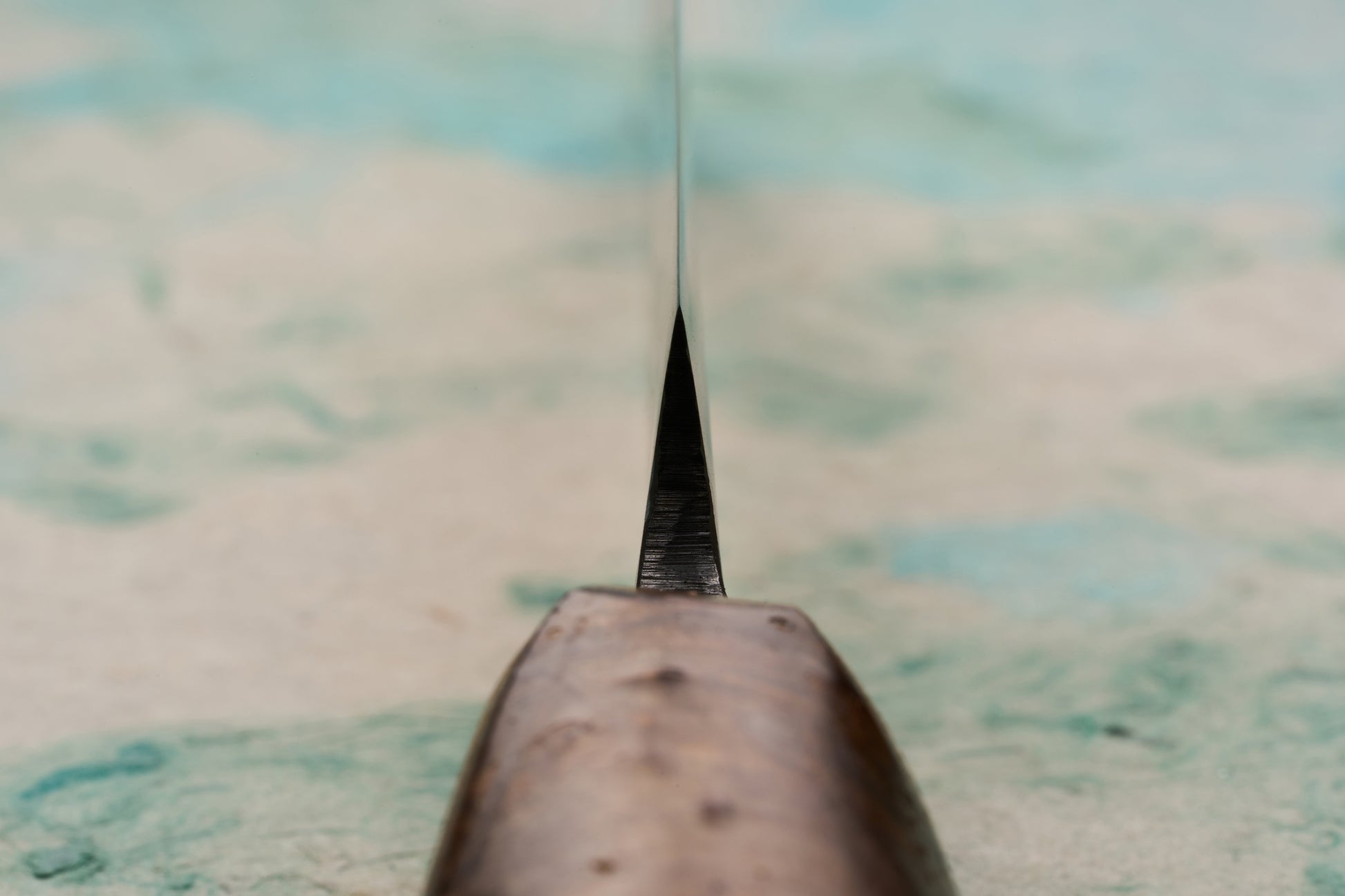 Close-up of the Tottori Otsuka Hamono Aoichi Samurai Knife 180mm, showcasing its thin blade extending towards the tip and the polished cherrywood handle, embodying masterful craftsmanship and sharp precision.