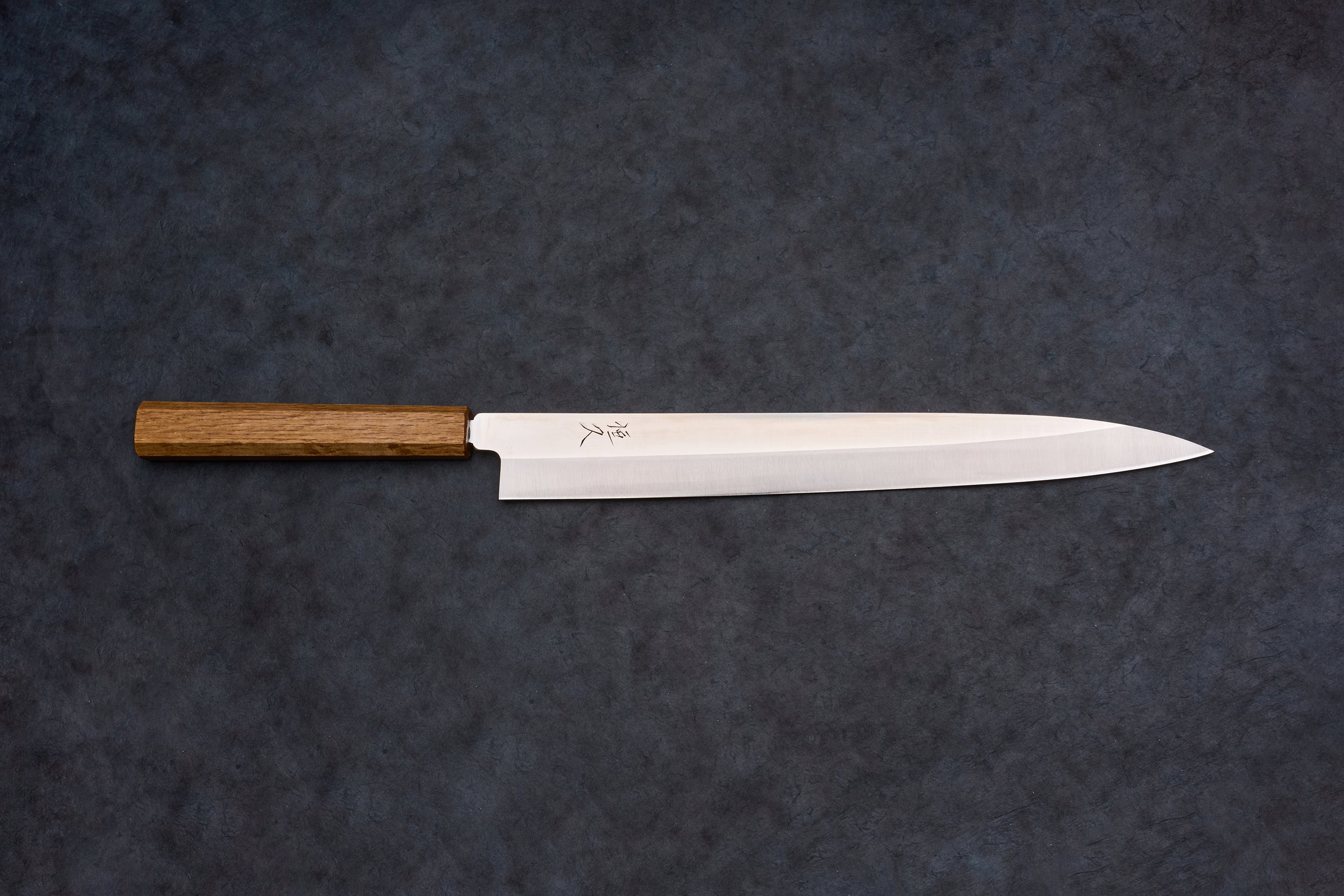 Tsunehisa AUS8 Sanjukyu Yanagiba 300mm, a polished steel Japanese slicing knife with kanji engraving and octagonal wooden handle, ideal for precise sashimi cuts.